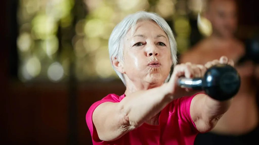 Toning Arms Without the Bulk: Is It Achievable? 1 Woman doing resistance band exercises for toned arms Felixstowe