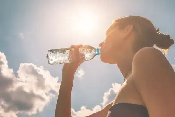 Hydration: The Secret Ingredient for a Toned Stomach and Enhanced Fitness 3 Image of woman drinking water to hydrate Felixstowe after run.